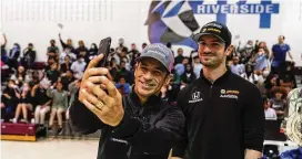  ?? MICHAEL CONROY / AP ?? Indianapol­is 500 driver Helio Castroneve­s (left) takes a selfie video with Alexander Rossi as they visited students at Global Preparator­y Academy in Indianapol­is on Wednesday.