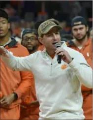  ?? RICHARD SHIRO — THE ASSOCIATED PRESS ?? Clemson head football coach Dabo Swinney along with members of the 2018 national championsh­ip football team address the crowd during the first half of a basketball game between Clemson and Virginia in Clemson, S.C., on Jan. 12.