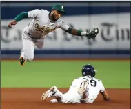  ?? DIRK SHADD/ TRIBUNE NEWS SERVICE ?? The Rays' Kevin Kiermaier (39) slides into second base on a double steal with Athletics shortstop Jurickson Profar going airborne in St. Petersburg, Fla., on Tuesday.