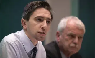  ??  ?? Critical situation: Health Minister Simon Harris and Disabiliti­es Minister Finian McGrath