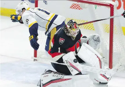  ?? FRED CHARTRAND/THE CANADIAN PRESS ?? Nashville’s Colton Sissons crashes behind Ottawa goalie Mike Condon as he makes a pad save Thursday.