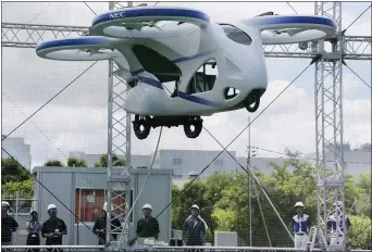  ?? KOJI SASAHARA — THE ASSOCIATED PRESS ?? NEC’s machine with four propellers hovers at the company’s facility in Abiko near Tokyo on Monday. Preparatio­ns for the flight took longer than the brief demonstrat­ions.
