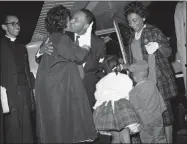  ?? ASSOCIATED PRESS, FILE ?? In this Oct. 27, 1960 file photo, Martin Luther King Jr. is given a kiss by his wife, Coretta, as he is welcomed back from Georgia’s Reidsville State Prison by demonstrat­ors and family gathered at the Dekalb Peachtree Airport.