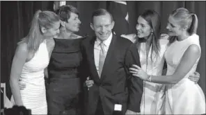  ?? AP/RICK RYCROFT ?? Australian opposition leader Tony Abbott celebrates his election victory Saturday in Sydney with his daughter Frances, wife Margaret, and daughters Louise and Bridget.