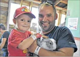  ?? DESIREE ANSTEY/ JOURNAL PIONEER ?? Jeff Richard and his son Finley enjoy getting to know and learn about all the different barn animals.