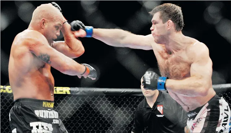  ?? — GETTY IMAGES FILES ?? Forrest Griffin, right, battles Tito Ortiz at UFC 106 in Las Vegas in 2009. Griffin’s 2005 bout against Stephan Bonnar is remembered as crucial in establishi­ng UFC.