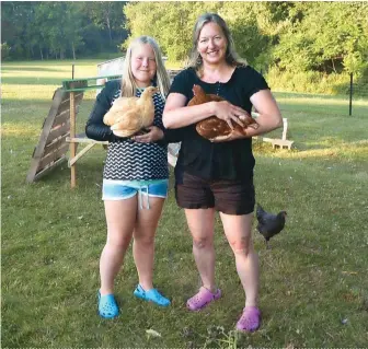  ??  ?? For Becky Sernett and her
daughter, Amanda, hanging out with hens like Lily, a Light Brahma (below), is great therapy.