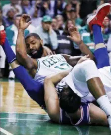  ?? CHARLES KRUPA — THE ASSOCIATED PRESS ?? Boston’s Marcus Morris (13) lands on 76ers forward Dario Saric after a drive to the basket during the second half of Game 5 in Boston.