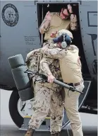  ??  ?? A Canadian soldier is given a hug as they arrive in Gao, Mali. Left: Chief of the Defence Staff General Jonathan Vance arrives with the first Canadian troops.