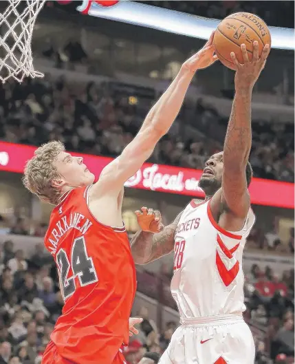  ?? | CHARLES REX ARBOGAST/ AP ?? Bulls rookie Lauri Markkanen blocks Rockets forward Tarik Black’s shot in the first half Monday night.