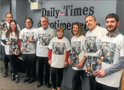  ?? DIGITAL FIRST MEDIA PHOTO ?? Daily Times staff members model special T-shirts the company made up commemorat­ing the Eagles big win in Super Bowl LII and the front page that appeared the next morning, Feb. 5. Also on display are copies of the special glossy magazine, ‘A Season to...