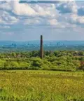  ??  ??  THE LONG & SHORT VIEW
Left and below:
A Bolton chimney and the Manchester skyline, as seen from the lane closed off by Colonel Ainsworth.