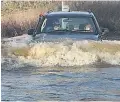  ??  ?? FLOODY HELL Car in water at Ingateston­e, Essex, yesterday