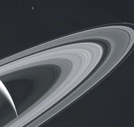  ?? Picture: AFP PHOTO / NASA/JPL-CALTECH/SPACE SCIENCE INSTITUTE. ?? NIGHT LIGHT: This Cassini image, obtained from NASA, shows the rings of Saturn and the icy moon Tethys on May 13.