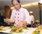  ??  ?? DESSERT MASTER. Chef Jac having her time preparing “3 Kinds of Mango” salad.