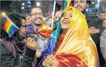  ?? AP ?? People celebrate in a park in Bogota on Wednesday as they listen to the announceme­nt from Havana, Cuba, that delegates of Colombia’s government and leaders of the Farc reached a peace accord to end their half-century civil war.