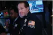  ?? GETTY IMAGES ?? Traders work on the floor of the New York Stock Exchange on Tuesday.