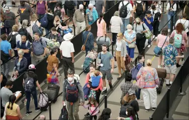  ?? ASSOCIATED PRESS FILE PHOTO ?? Travelers queue up at the south security checkpoint in Denver Internatio­nal Airport as the Labor Day holiday approaches, Aug. 30, in Denver.