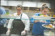  ??  ?? Above left: Graduate Raymond Luna gets his plate during the Hope Harbor Culinary Arts program graduation at the Salvation Army in Lodi on Tuesday. Above right: Laurie Crall, a graduate of the class of 2008, and Rebecca Bayers, who will be joining the...