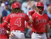  ?? LINDSEY WASSON – THE ASSOCIATED PRESS ?? The Angels’ Brett Phillips celebrates his solo home run with rookie Kyren Paris in the third inning of a 3-2loss to the Seattle Mariners on Wednesday afternoon.