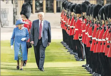  ?? AP/RICHARD POHLE ?? Britain’s Queen Elizabeth II and President of the United States Donald Trump inspect the Guard of Honour Friday during the president’s visit to Windsor Castle in Windsor, England. The monarch welcomed Trump in the courtyard of the royal castle.