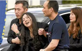  ?? —AP ?? HEARTWRENC­HING Hui Wang cries after the memorial service for her 15-year-old son Peter whowas killed in the shooting at Marjory Stoneman Douglas High School.