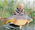  ??  ?? Vinny Parker with Captain Jack, the 69lb 10oz carp deemed too big when imported
