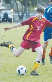  ??  ?? Campbell Hill boots Drouin Dragons into attack during the under 16 match against Phillip Island.