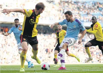  ?? AFP ?? Manchester City’s Bernardo Silva, second right, scores the team’s sixth goal against Watford at the Etihad Stadium.