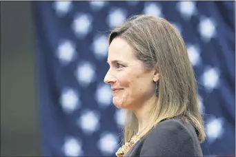  ?? ALEX BRANDON — THE ASSOCIATED PRESS ?? Judge Amy Coney Barrett listens as President Donald Trump announces Barrett as his nominee to the Supreme Court, in the Rose Garden at the White House, Saturday, Sept. 26, 2020, in Washington.