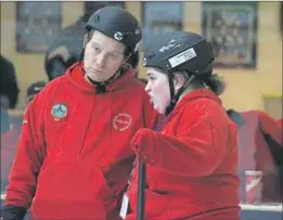  ?? - John DeCoste, www.kingscount­ynews.ca ?? Kings 2 curling skip Bruce Lightle, left, and mate Tammy McMillan discuss Lightle’s upcoming shot during Special Olympics curling action Feb. 20 at the Glooscap Curling Club in Kentville.