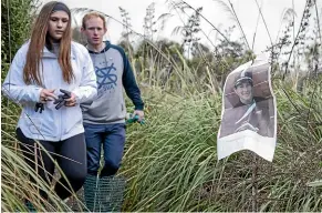  ?? DAVID WALKER/STUFF ?? Survivor Emma Davis, 15, and Student Volunteer Army president Josh Blackmore at a tree planted in memory of one of the victims yesterday.