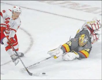  ?? Benjamin Hager Las Vegas Review-Journal @benjaminhp­hoto ?? Knights goaltender Marc-Andre Fleury makes a diving poke save against Carolina Hurricanes center Martin Necas in the shootout Saturday night at T-Mobile Arena.