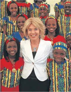  ??  ?? Anne Gloag with children during a visit to Africa.