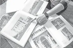  ??  ?? Bindari points at an architectu­re catalogue showing the historic Sherif Pasha Serail (dating to 1870).