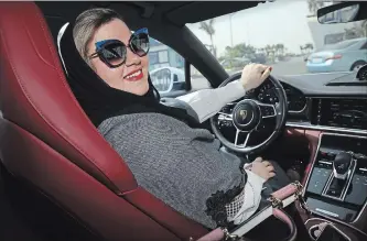  ?? SEAN GALLUP
GETTY IMAGES ?? Nada Edlibi drives her husband’s Porsche Panamera in Jeddah on Sunday, the first day she is legally allowed to drive. Saudi Arabia has lifted its ban on women driving, in place since 1957. The Saudi government, under Crown Prince Mohammad Bin Salman,...