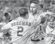  ?? Karen Warren / Houston Chronicle ?? Third baseman Alex Bregman, left, and shortstop Carlos Correa are both 23 and should anchor the left side of the Astros’ infield for many years to come.