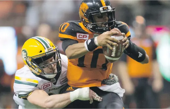  ?? THE CANADIAN PRESS ?? Adam Kona hauls down B.C. quarterbac­k Jonathon Jennings for one of five sacks the Eskimos defence registered in beating the Lions on Saturday night at B.C. Place.
