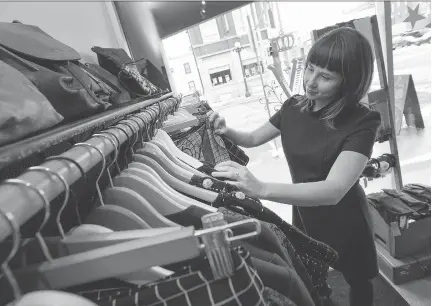  ?? WAYNE CUDDINGTON/ OTTAWA CITIZEN ?? Ottawa singer Jill Zmud scours the racks at Victoire boutique’s Dalhousie Street location to find that special dress to wear to the Canadian Folk Music Awards on Saturday. She has received her first nomination for contempora­ry album of the year.