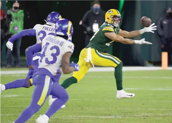  ?? GETTY IMAGES ?? Packers receiver Allen Lazard gets behind the Rams’ defense and hauls in a 58-yard touchdown pass from Aaron Rodgers in the fourth quarter Saturday at Lambeau Field.