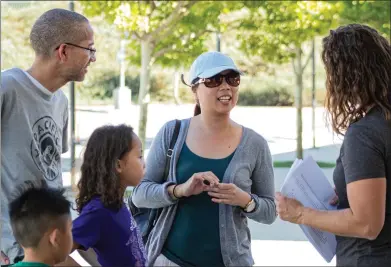  ?? Bobby Block/ The Signal ?? Vice Principal Jenna Oikawa greets a family attending back-to-school night. Sulphur Springs Union School District remains one of the oldest, but officials maintain forward-thinking objectives with an emphasis on STEAM programs.