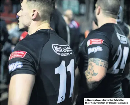  ??  ?? &gt; Neath players leave the field after their heavy defeat by Llanelli last week