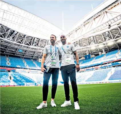  ??  ?? Medal in sight: Gareth Southgate and Fabian Delph at the stadium ahead of today’s match in St Petersburg