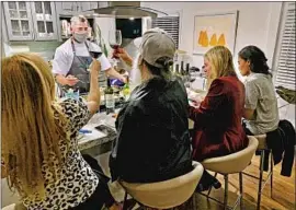  ?? Kevin Meehan ?? KEVIN MEEHAN cooks a meal for a customer’s gathering in December. Inhome events helped his restaurant, Kali, survive the COVID shutdowns, he says.