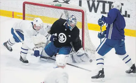  ?? CHRIS YOUNG THE CANADIAN PRESS ?? Maple Leafs goaltender Frederik Andersen makes a stop against centre Tyler Bozak, right, as centre Tomas Plekanec defends during a practice session in Toronto on Monday as the team prepares for its opening playoff round against the tough Boston Bruins.