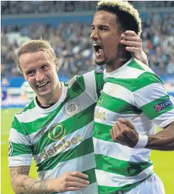  ?? Pictures: SNS/Getty Images. ?? Top: Leigh Griffiths fires Celtic into the lead; above: the striker celebrates with Scott Sinclair after the striker added an injury-time third for the Scottish champions; right: Anderlecht’s Adrien Trebel holds off Scott Brown.