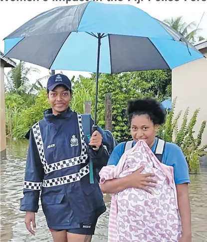  ?? Picture: FIJI POLICE FORCE. ?? Women officers assisting families evacuate in the Northern Division.
