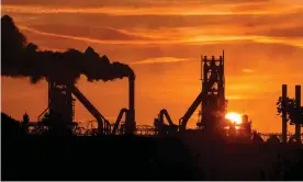  ??  ?? Smoke rises from the British Steel Scunthorpe plant in Lincolnshi­re. Current pledges on emissions cuts would take the world far beyond the 2C limit set in the 2015 Paris accord. Photograph: Lindsey Parnaby/AFP/Getty