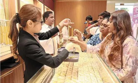  ?? — art CHEN/THE star ?? Big purchase: (From right) Tanalakshm­i, Kanagessar­y and parameswar­y looking at jewellery items at a gold shop in downtown Kuala lumpur.