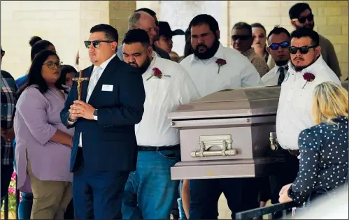  ?? (AP/Eric Gay) ?? Pallbearer­s carry the casket of Amerie Jo Garza on Tuesday following funeral services at Sacred Heart Catholic Church in Uvalde, Texas. Garza was killed in last week’s elementary school shooting. A video circulatin­g online incorrectl­y claims that because two different men were identified in TV news interviews as Garza’s father, it is proof that the shooting was a “hoax.”